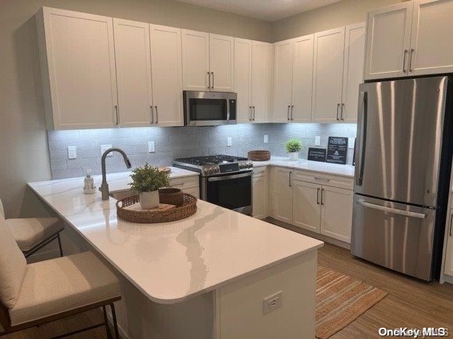 a kitchen with appliances a sink and cabinets