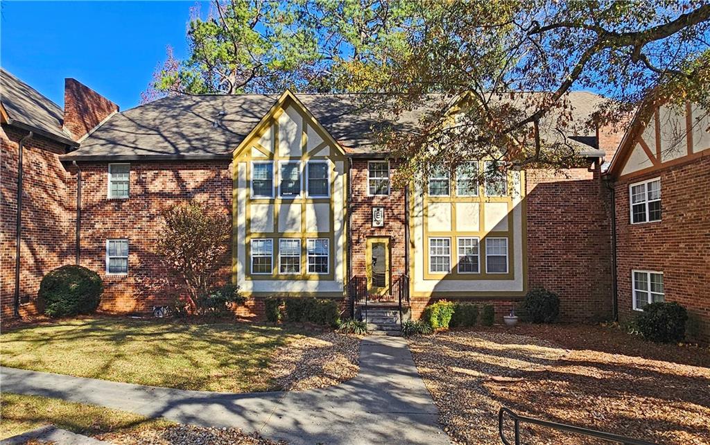 a view of a house with a tree in front