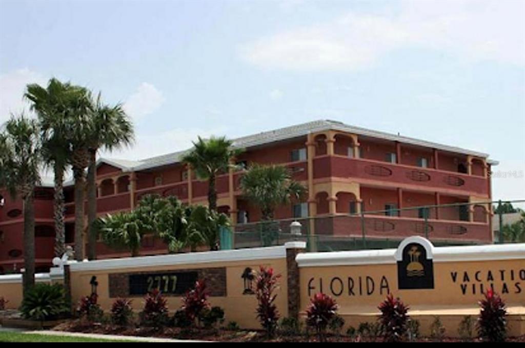 a front view of a building with street sign broad