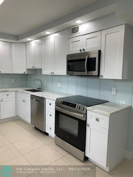 Updated kitchen with stainless steel appliances -STOVE is NEW and never used