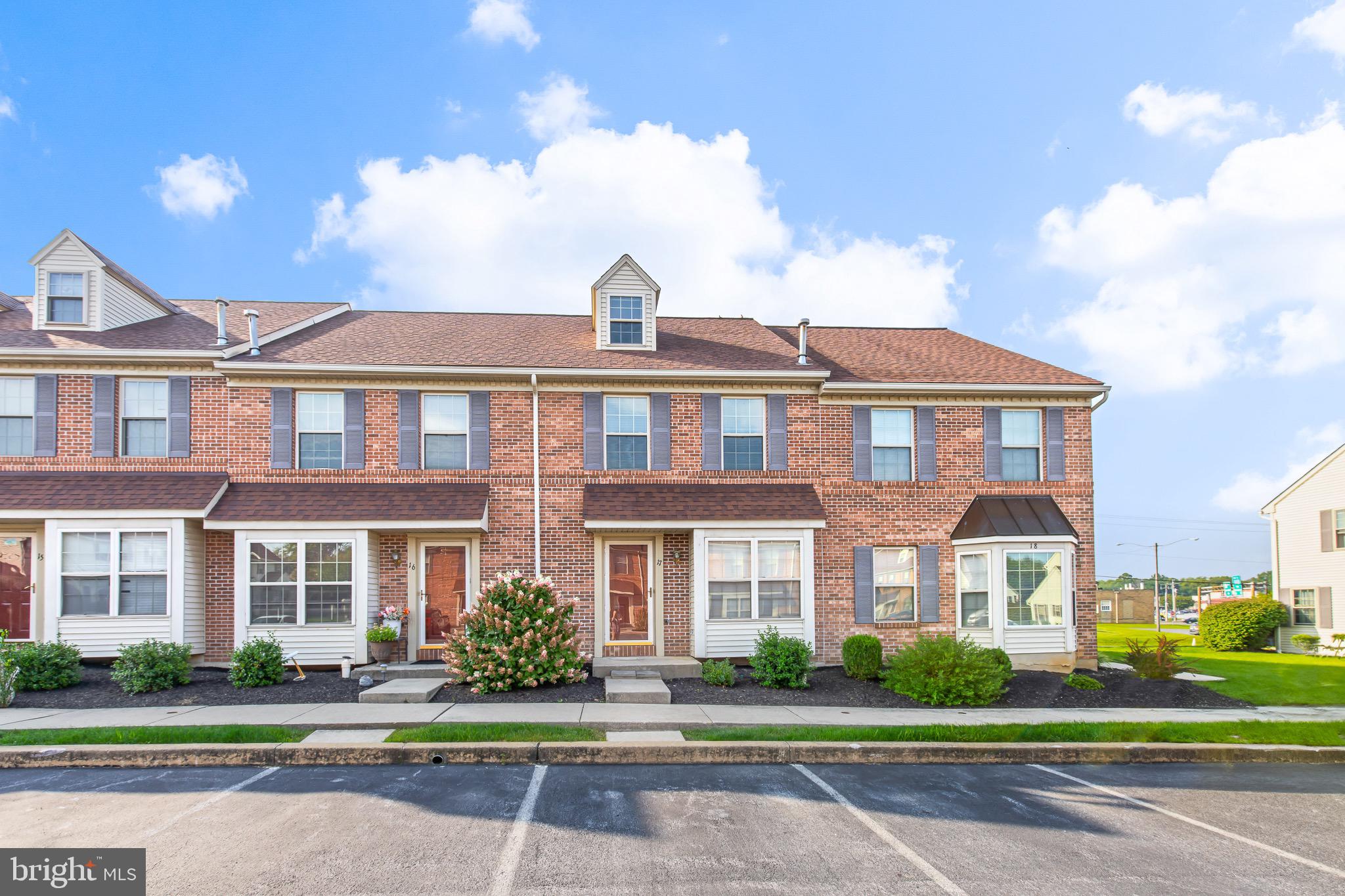 a front view of a residential apartment building with a yard