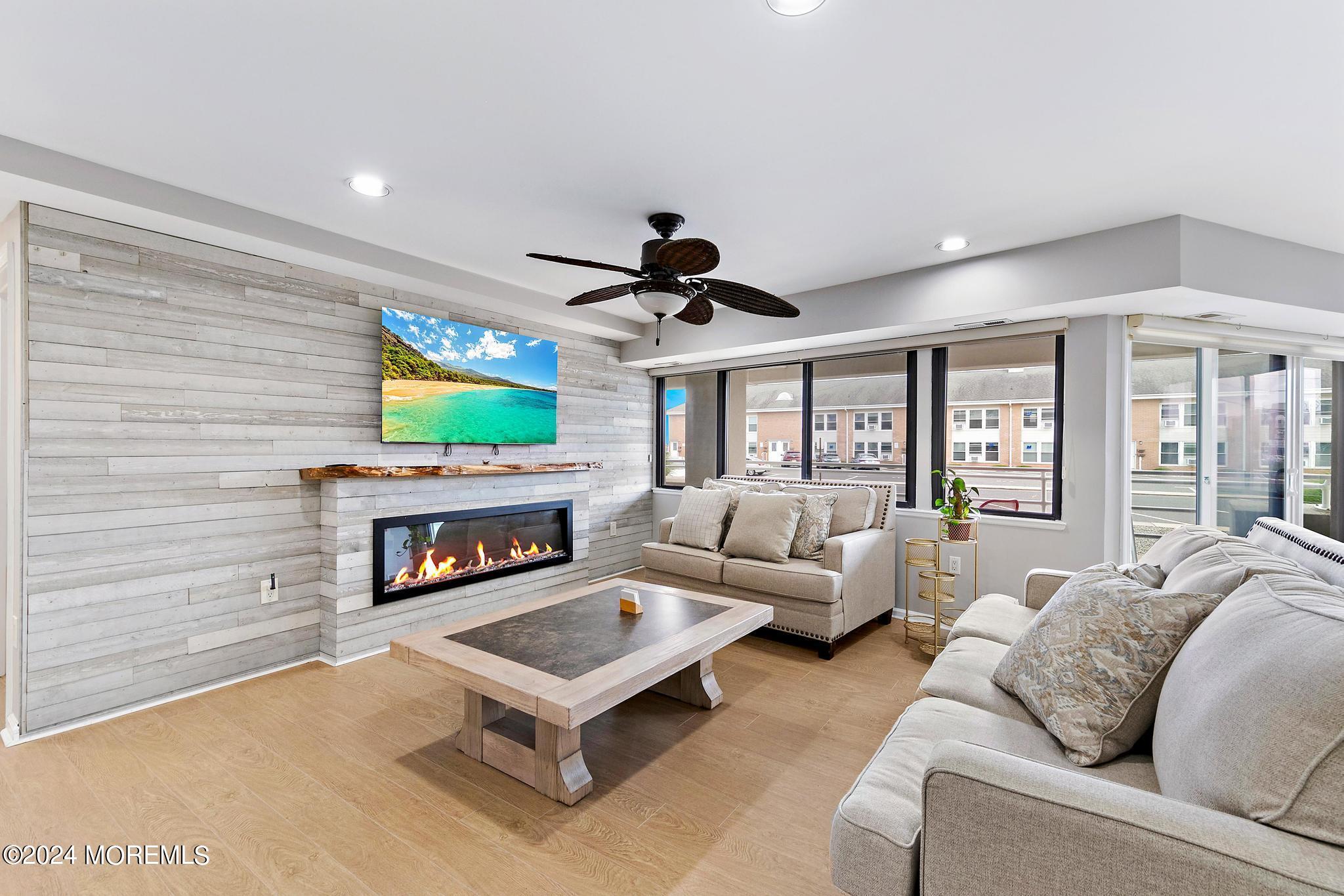 a living room with furniture a fireplace and a flat screen tv