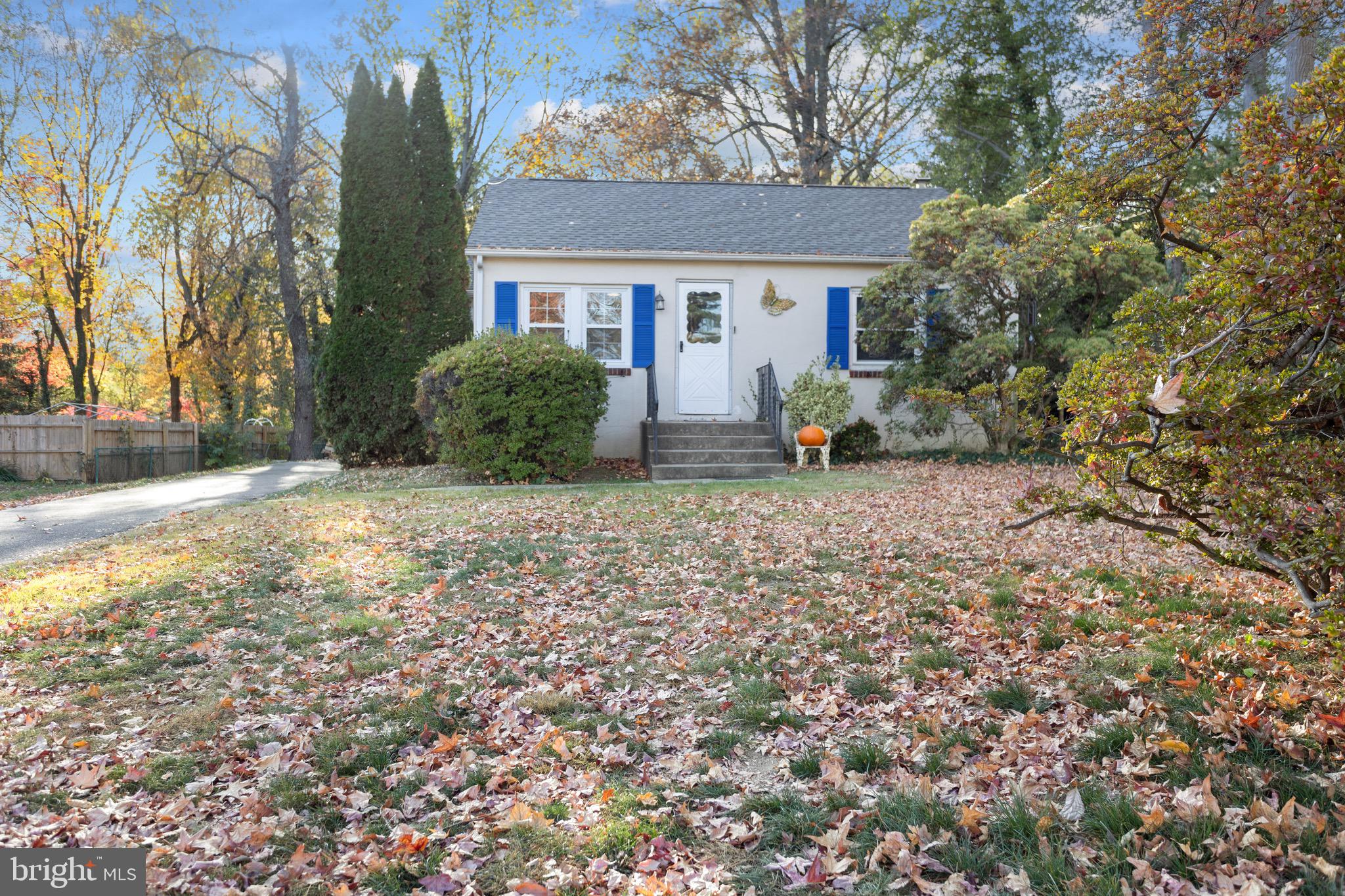 a view of a house with a yard and sitting area