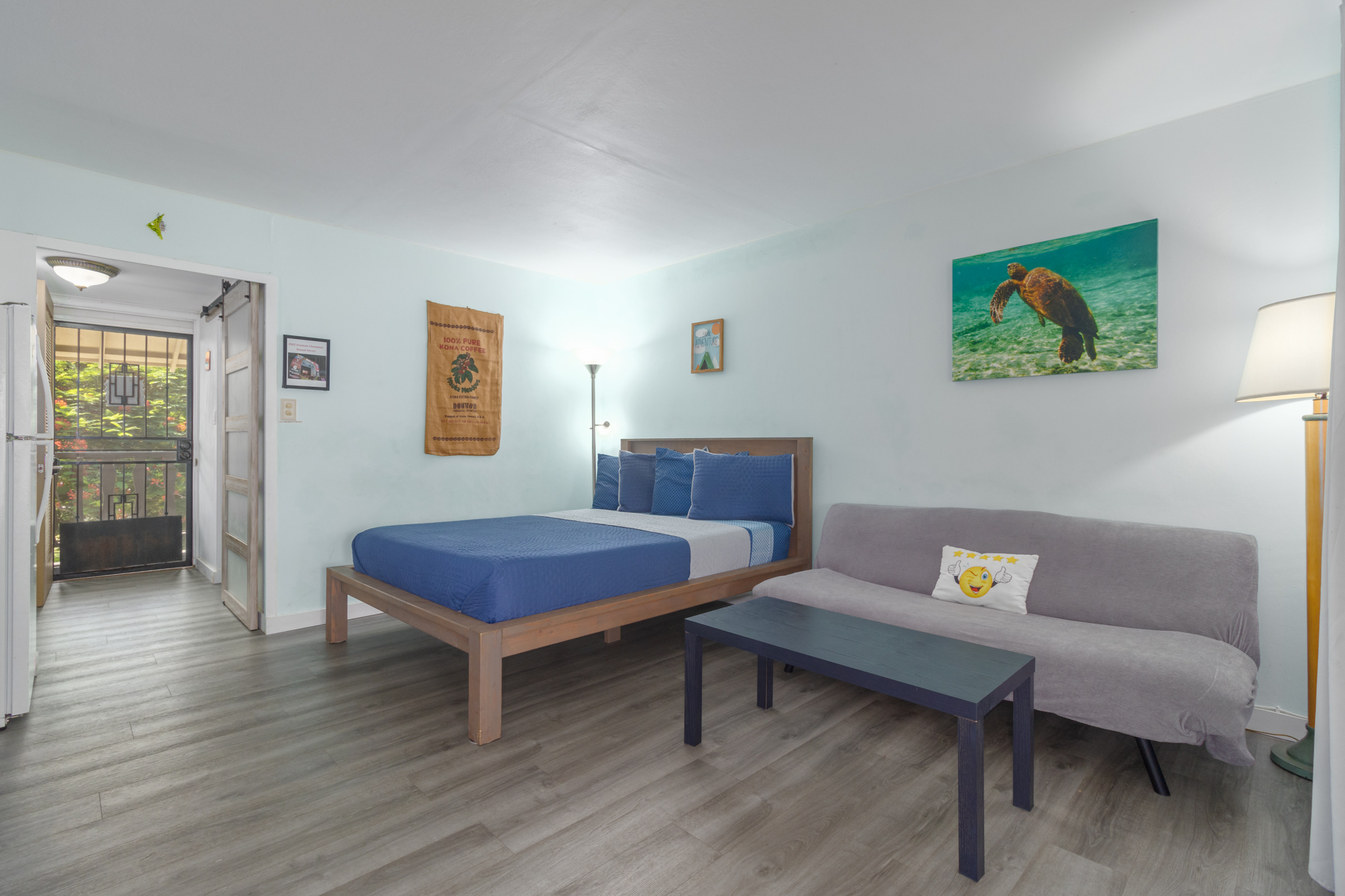 a living room with furniture and a wooden floor