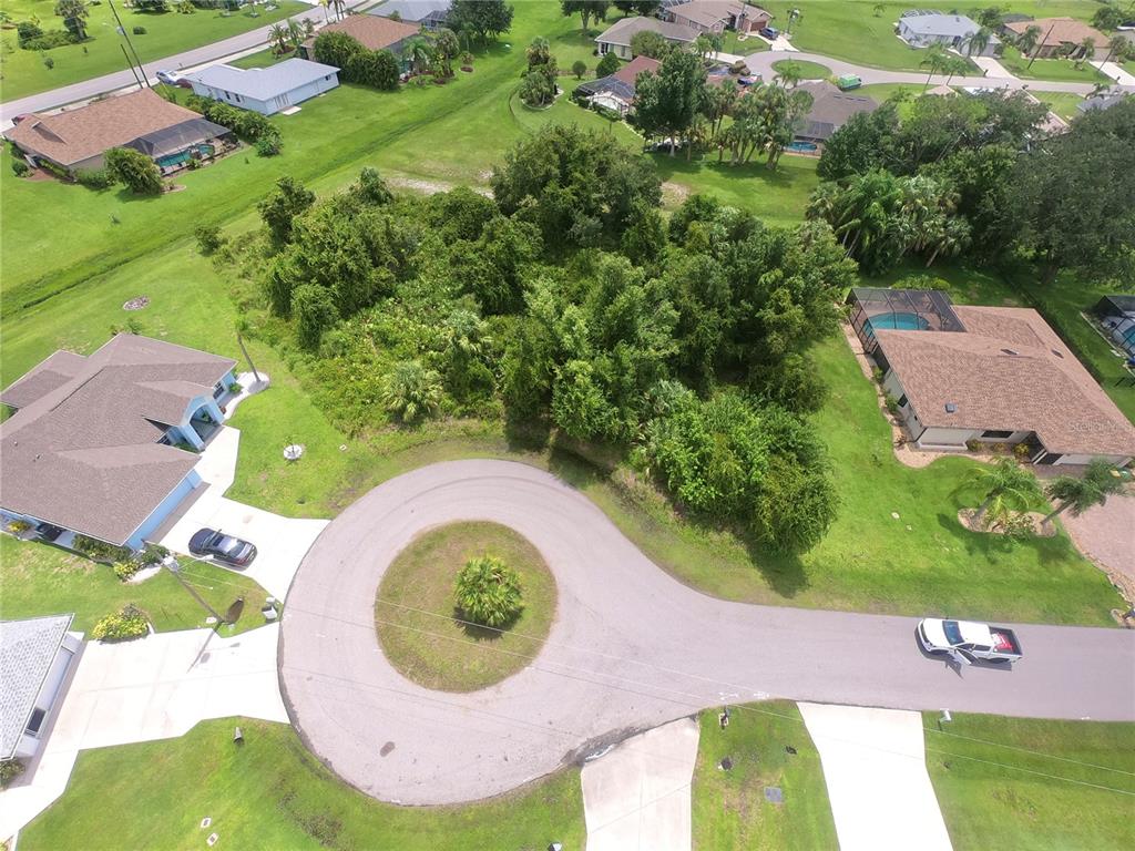 an aerial view of a house with a swimming pool and garden