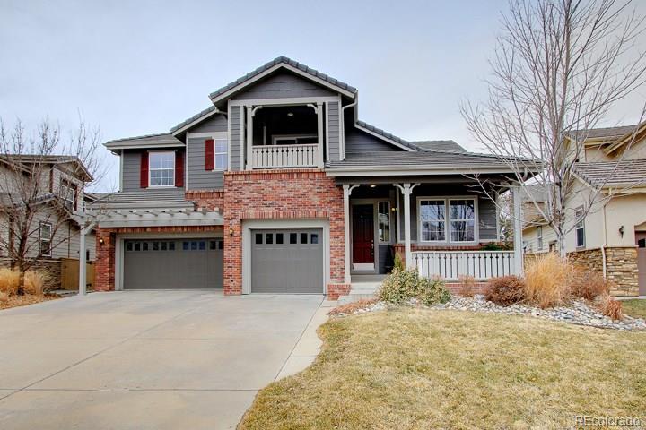 a front view of a house with yard and parking