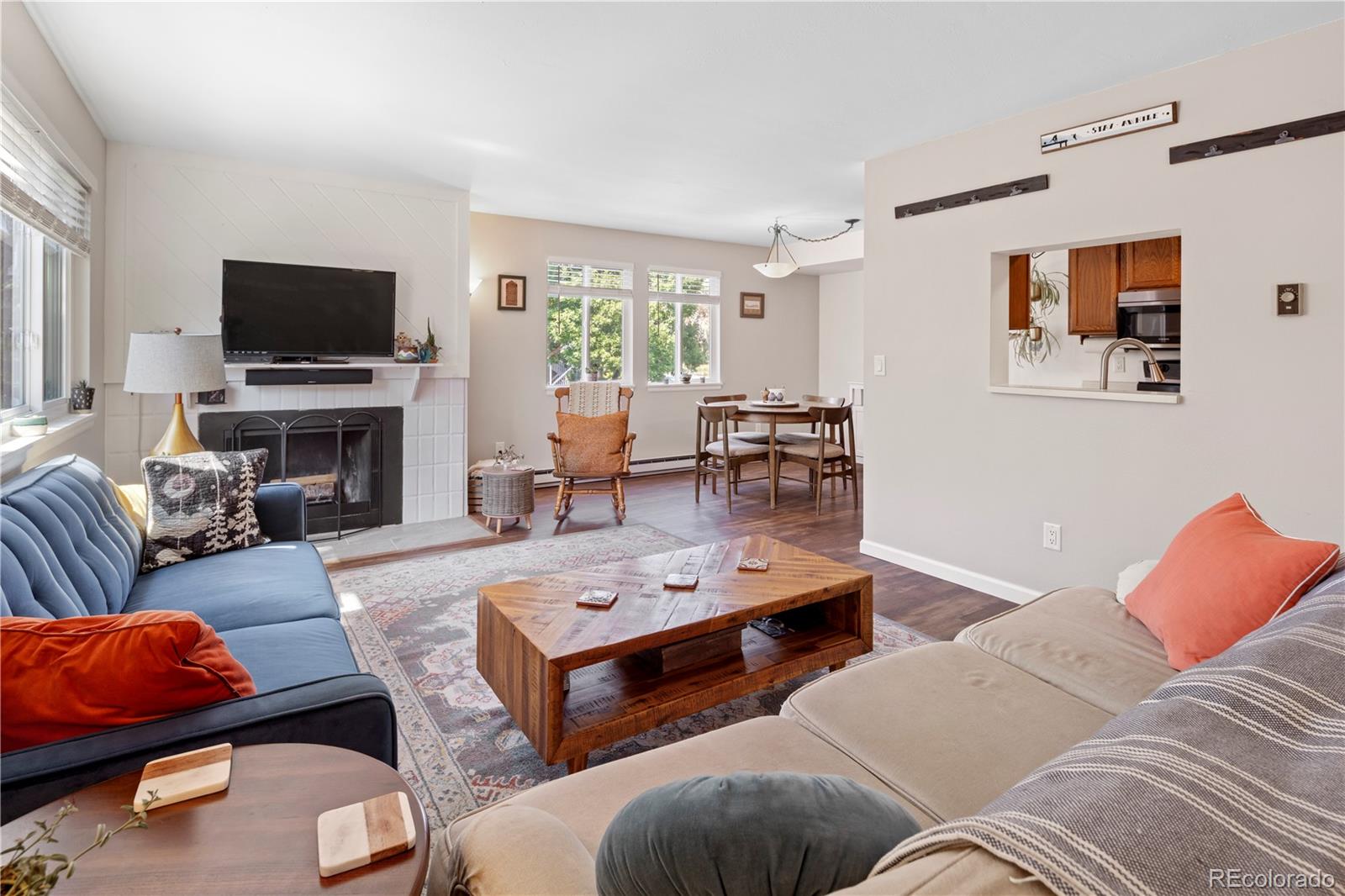 a living room with furniture a flat screen tv and a fireplace