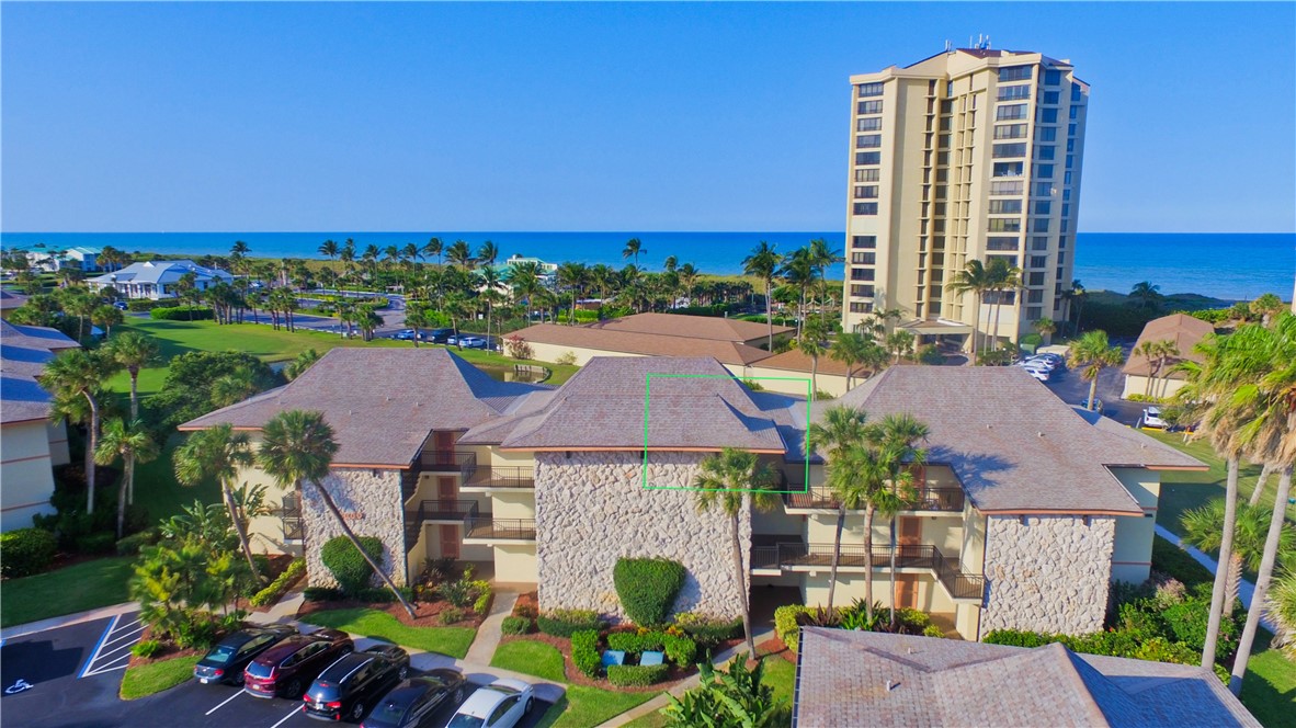 an aerial view of multiple houses with yard