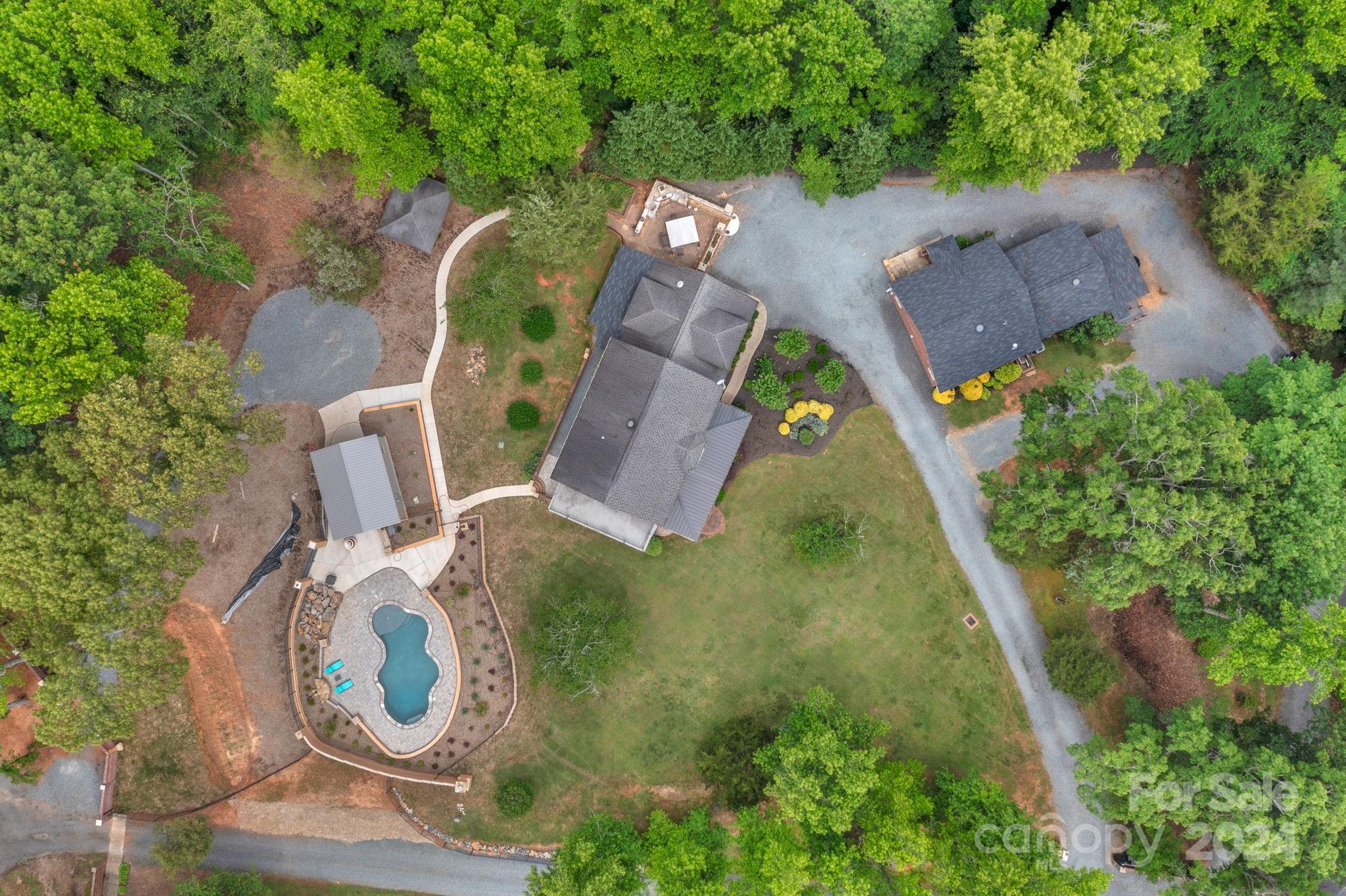 an aerial view of a house with outdoor space and a lake view