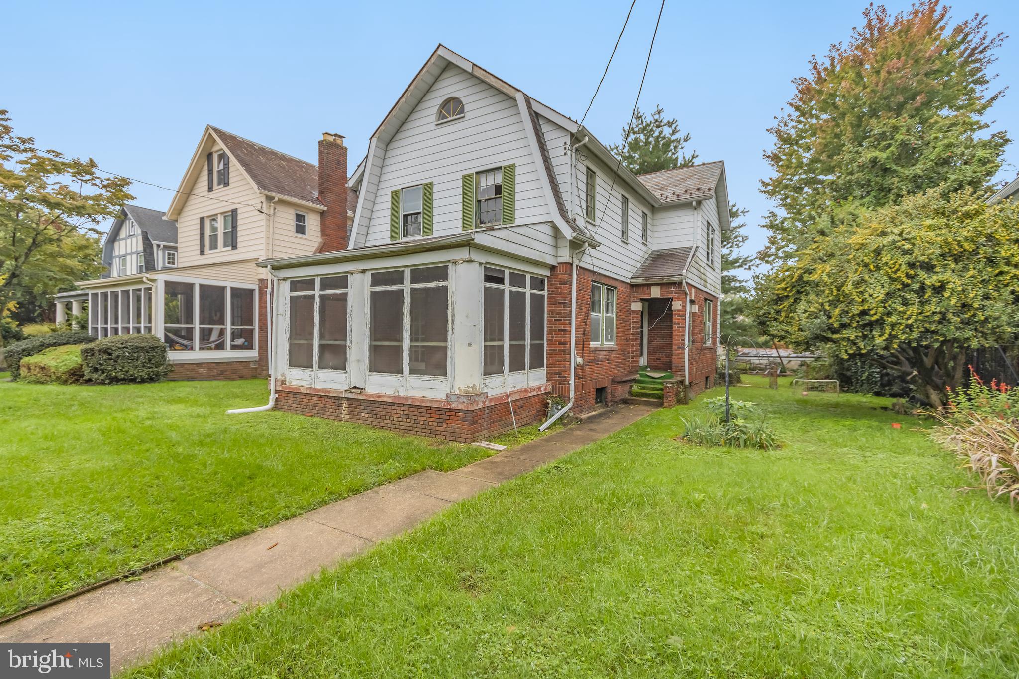 a view of a house with a yard and sitting area