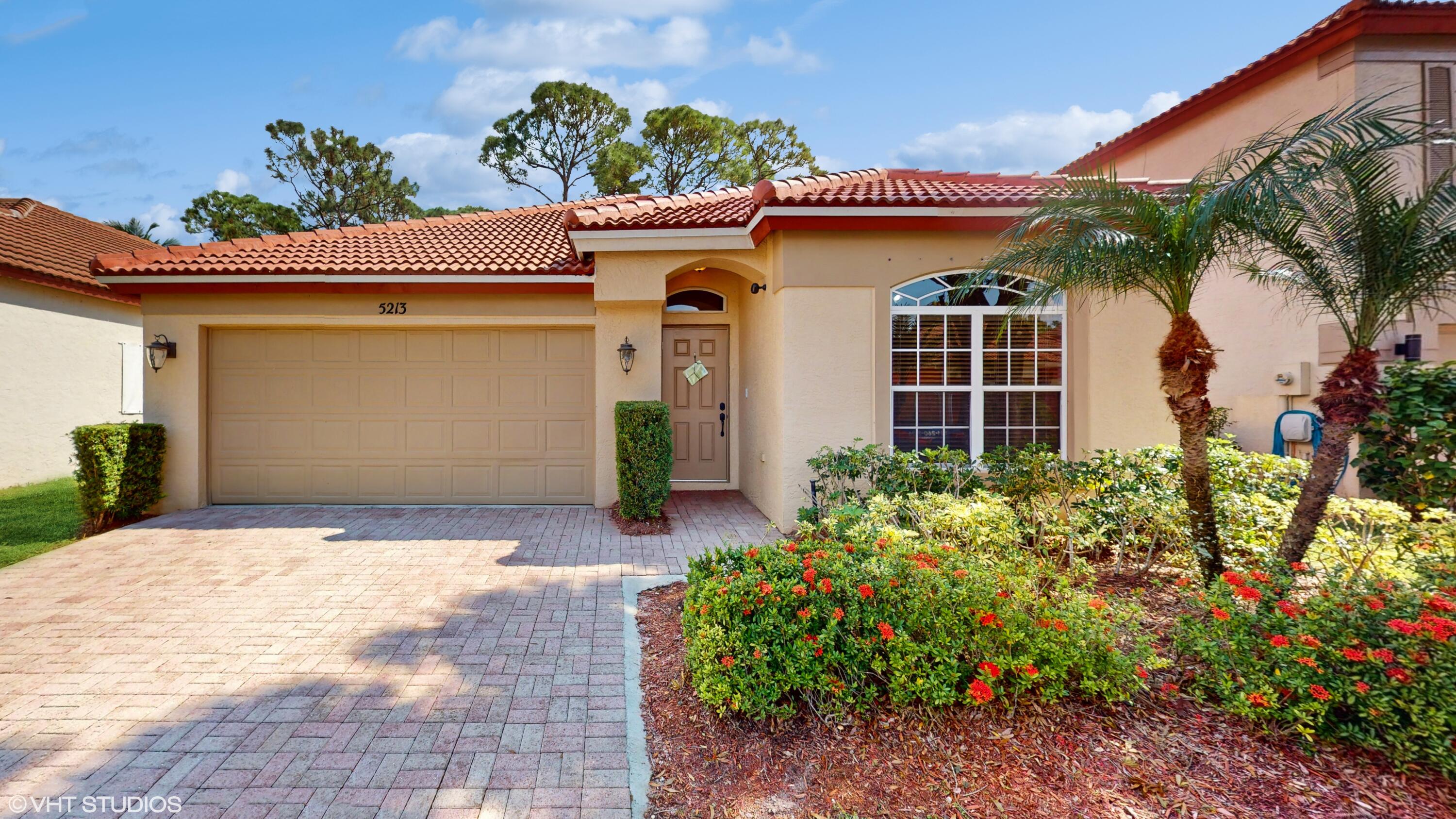 a front view of a house with a yard and a garage