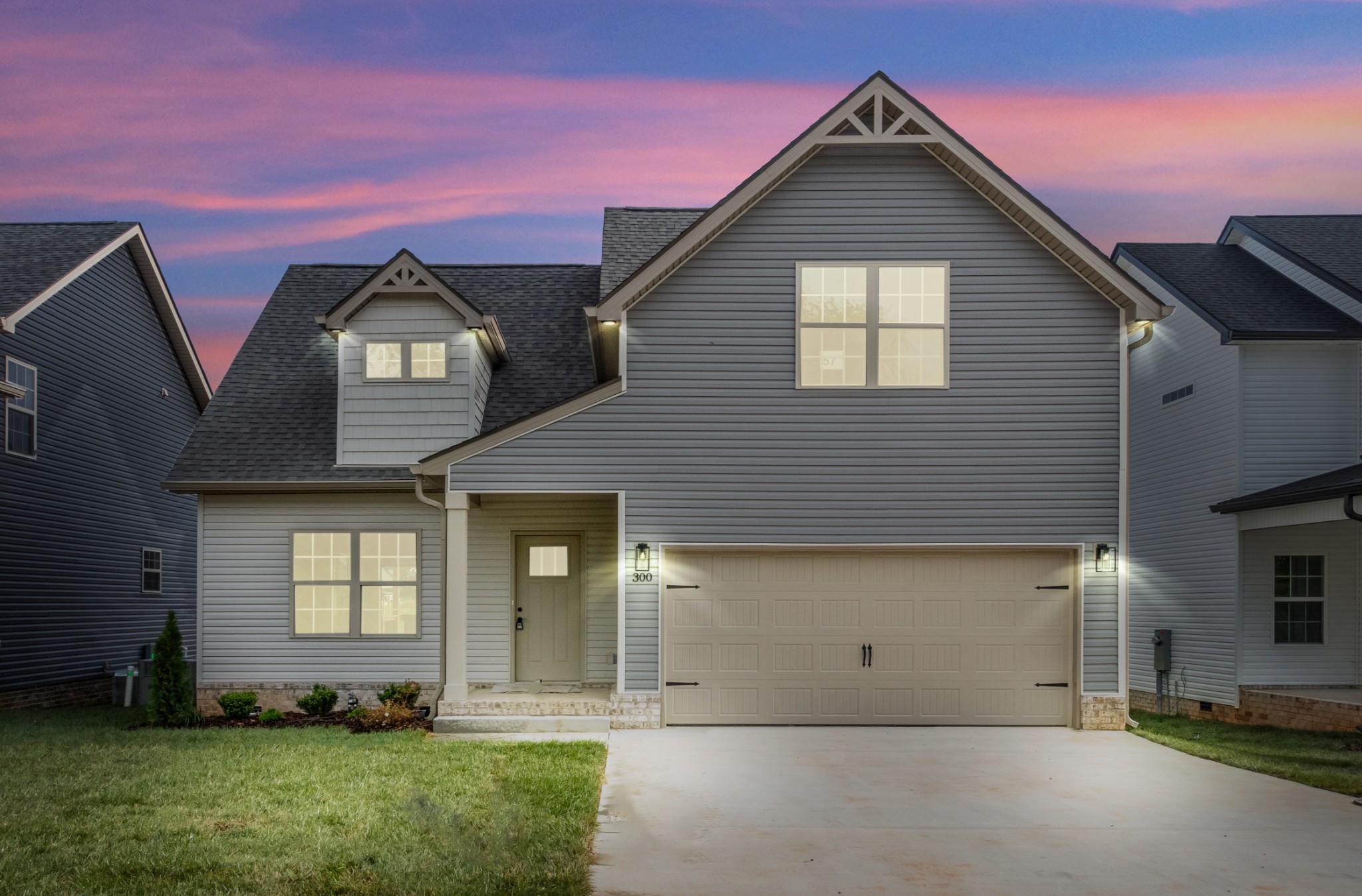 a front view of a house with a yard and garage