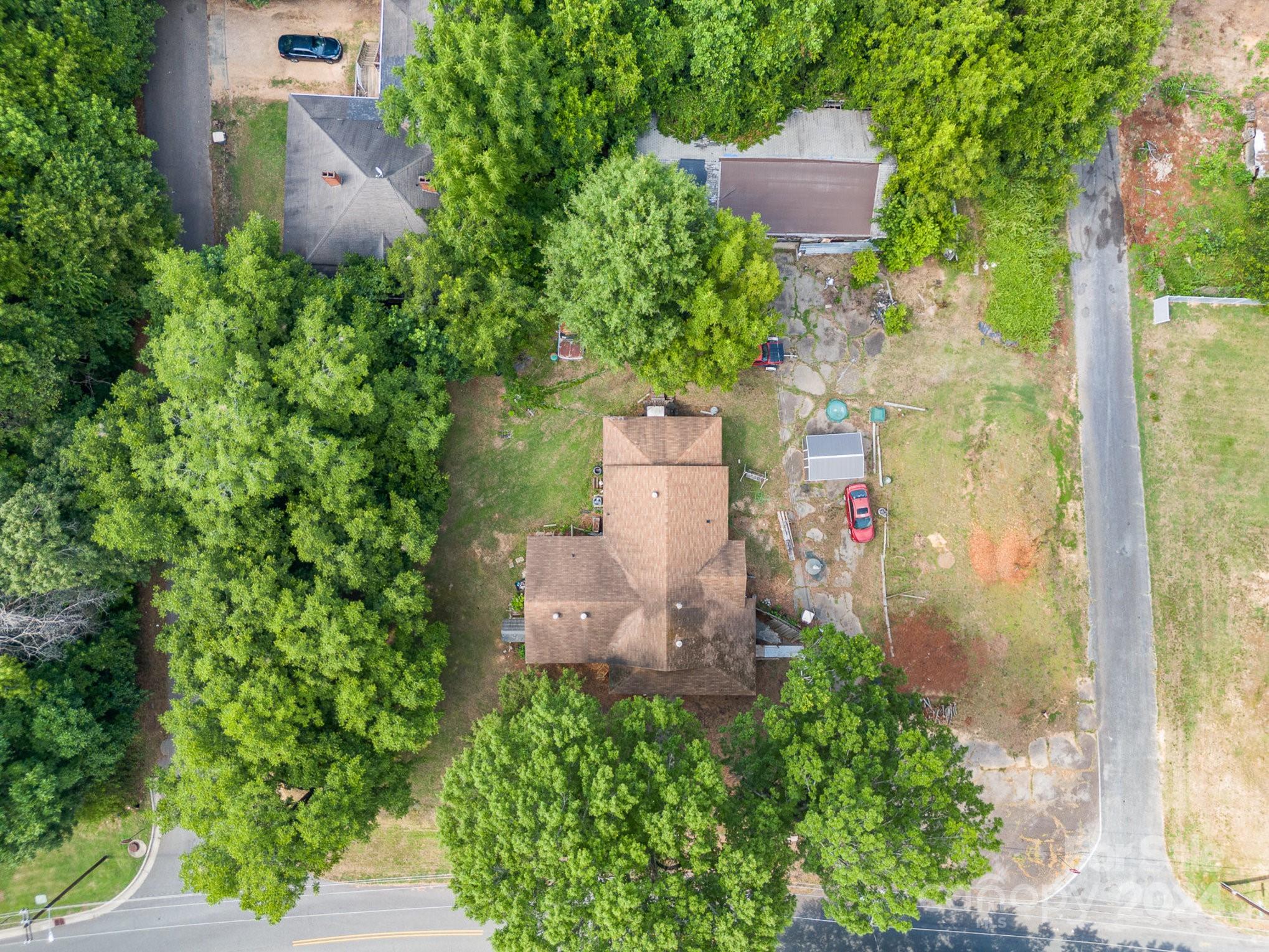 an aerial view of a house with a yard and garden