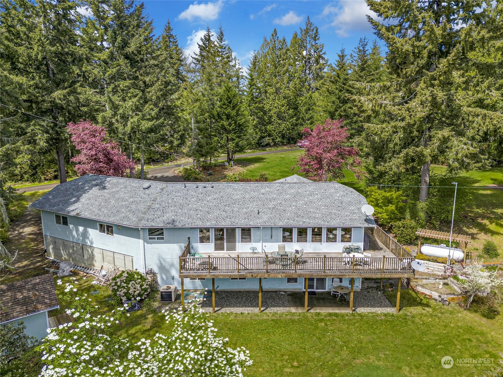 an aerial view of a house with table and chairs and a swimming pool