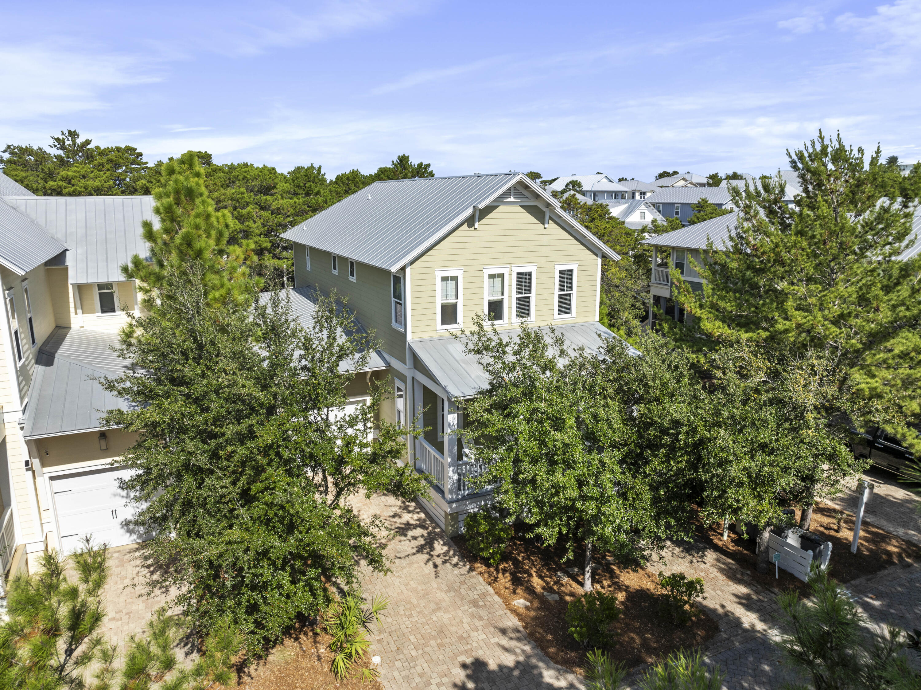 aerial view of a house with a yard and potted plants