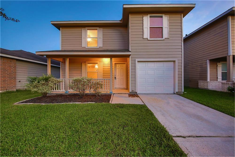 a front view of a house with a yard and porch