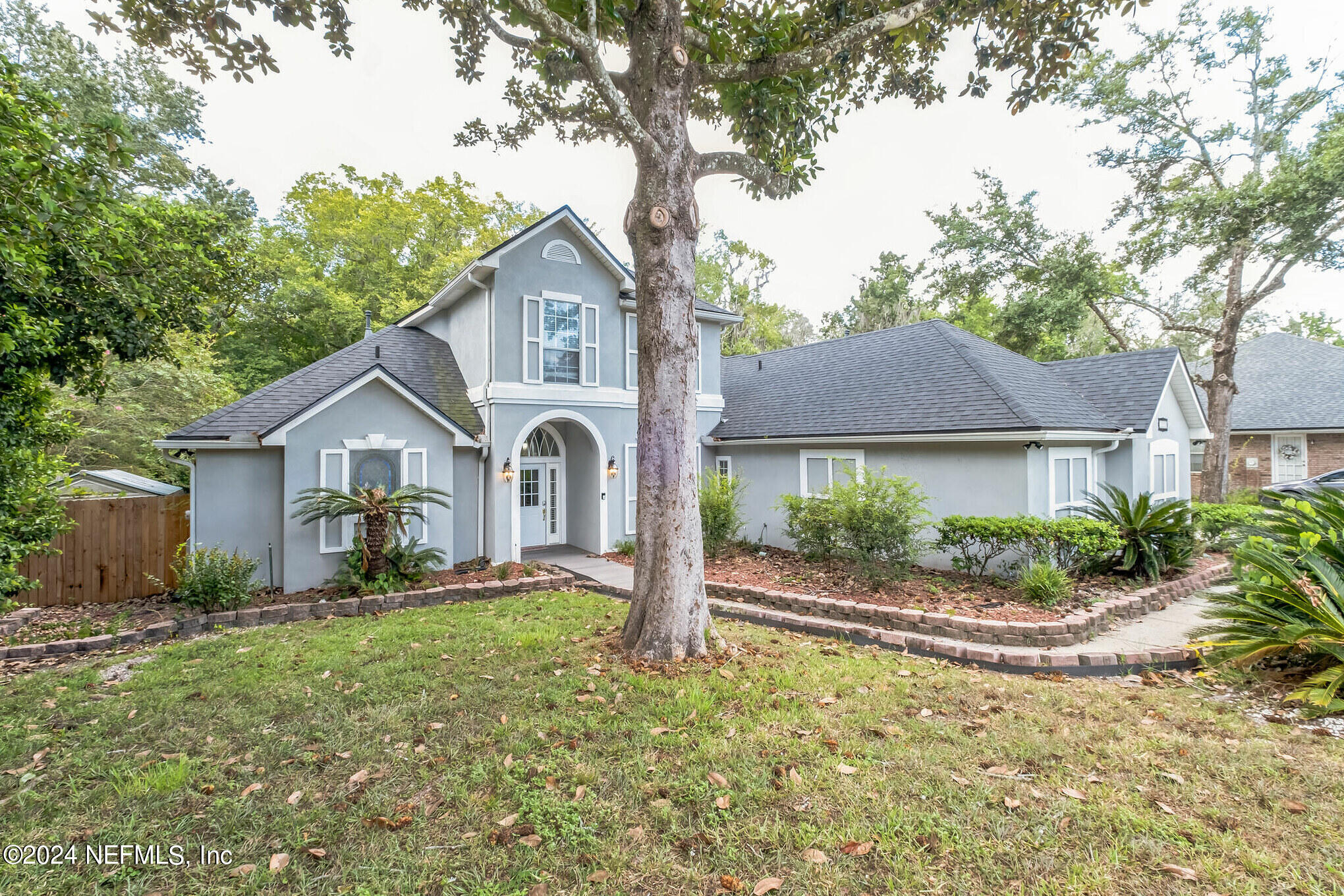 a front view of a house with garden