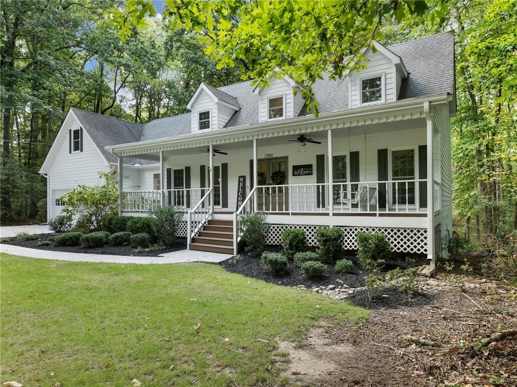 a view of a house with a yard and plants