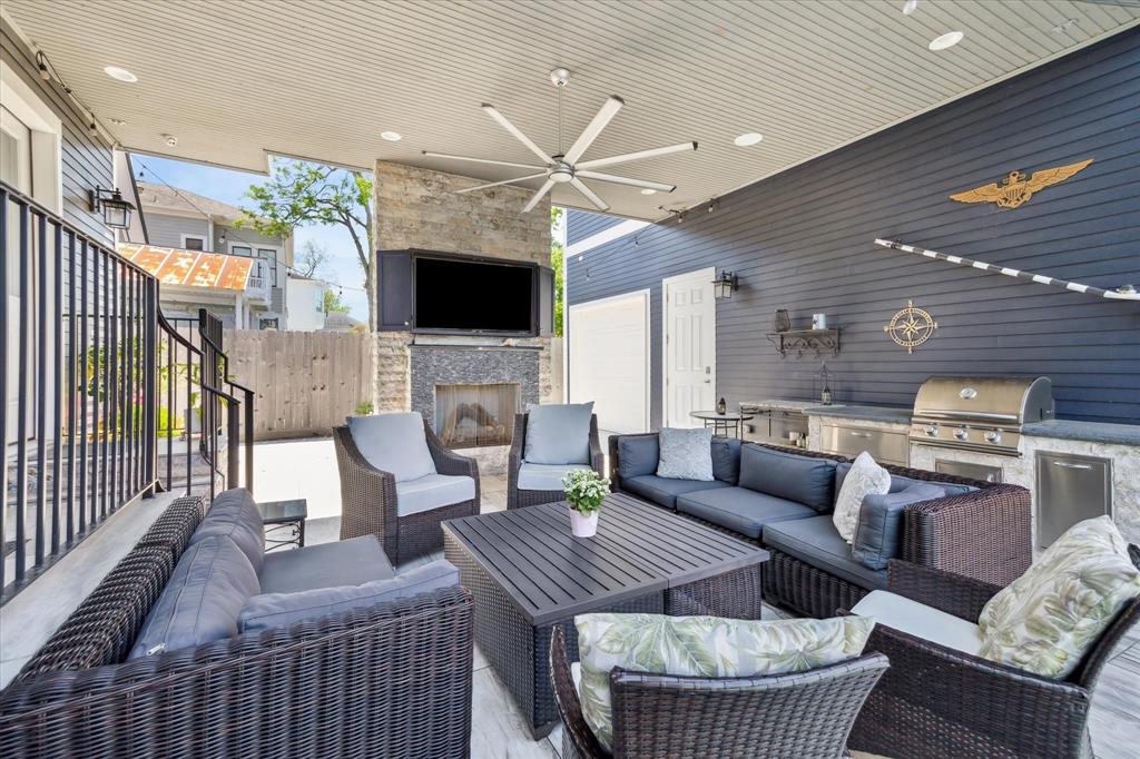 a living room with furniture a flat screen tv and a fireplace