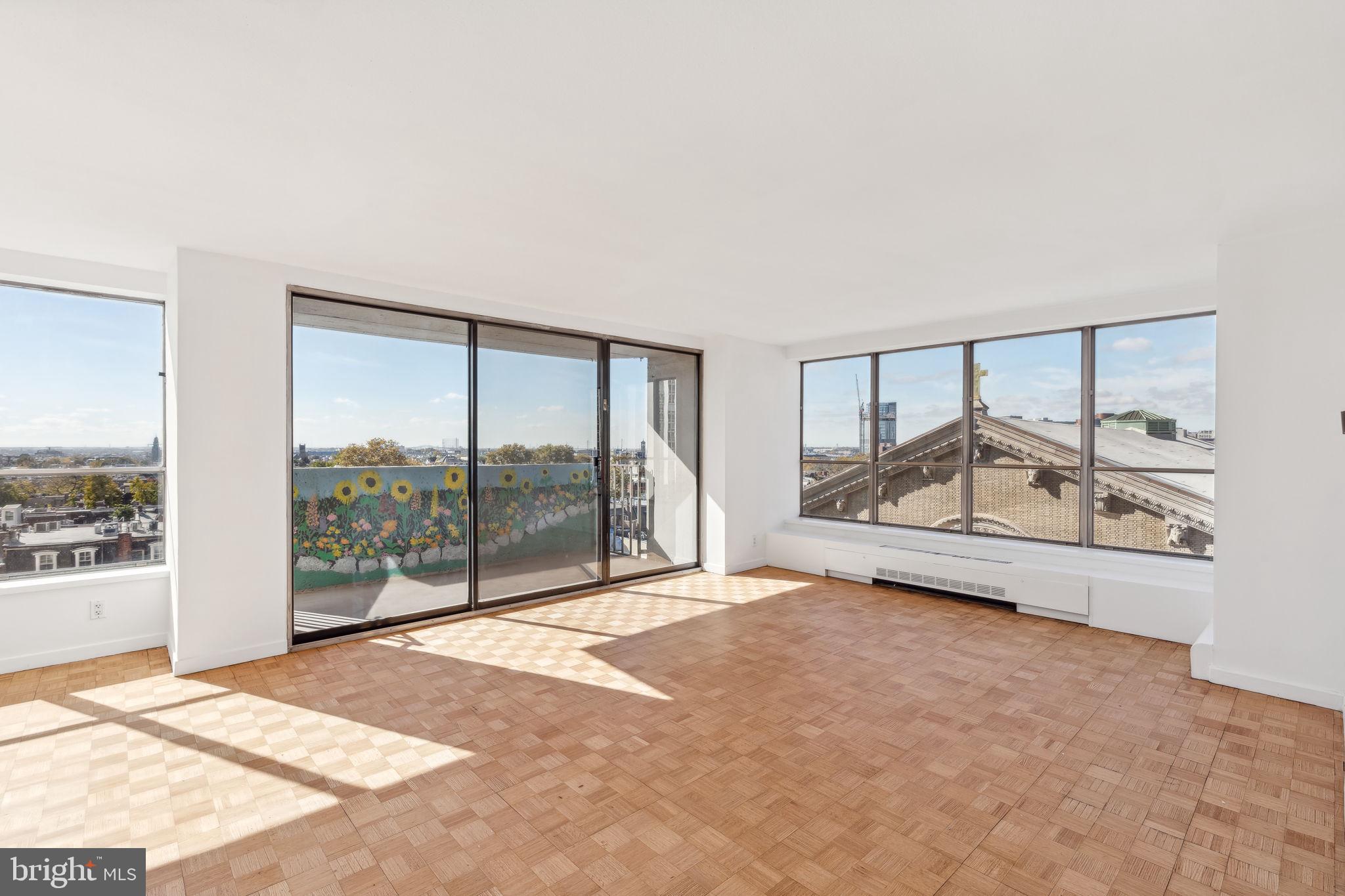 an empty room with sliding glass door and mountain view