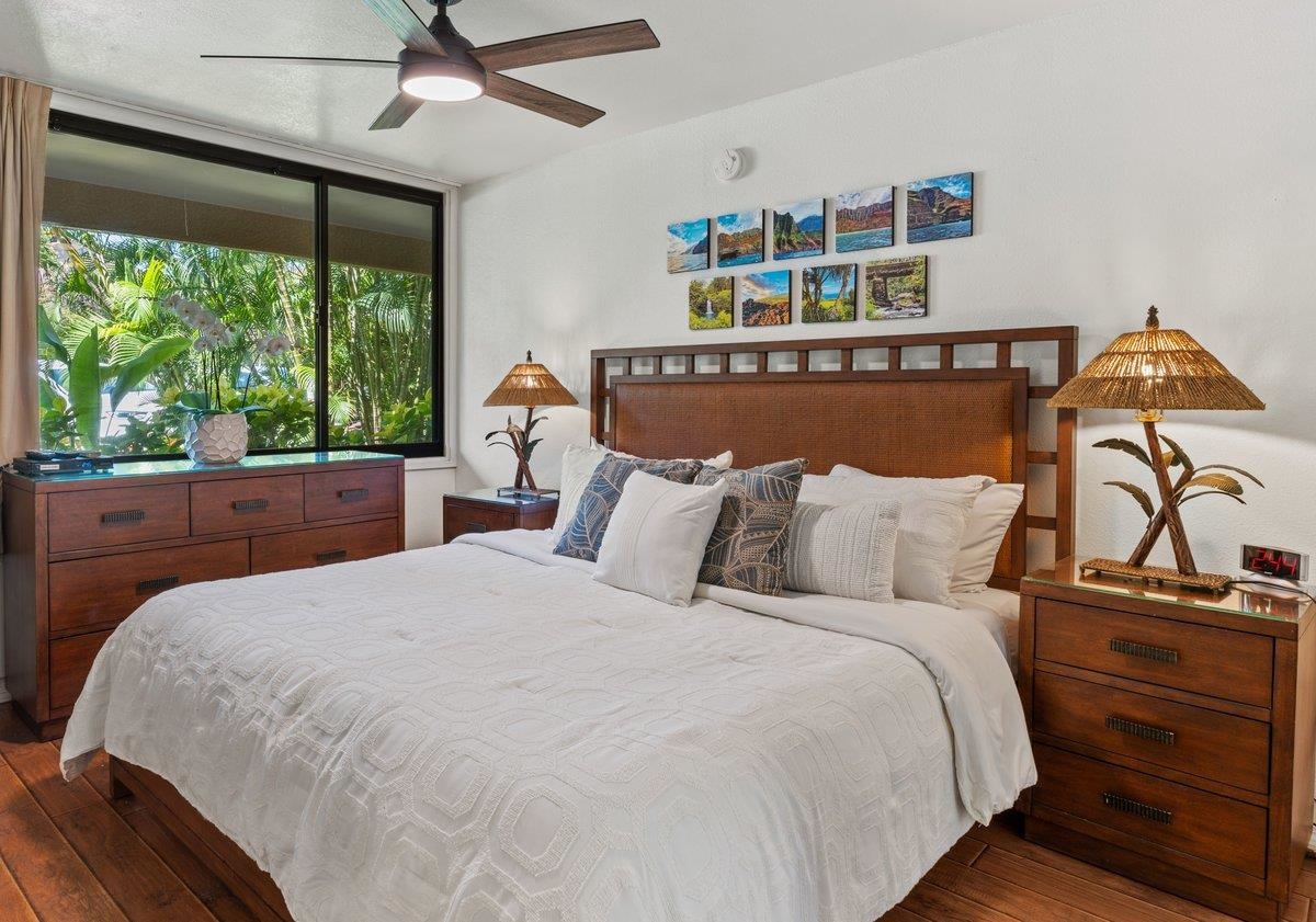 a bedroom with a bed and a large window