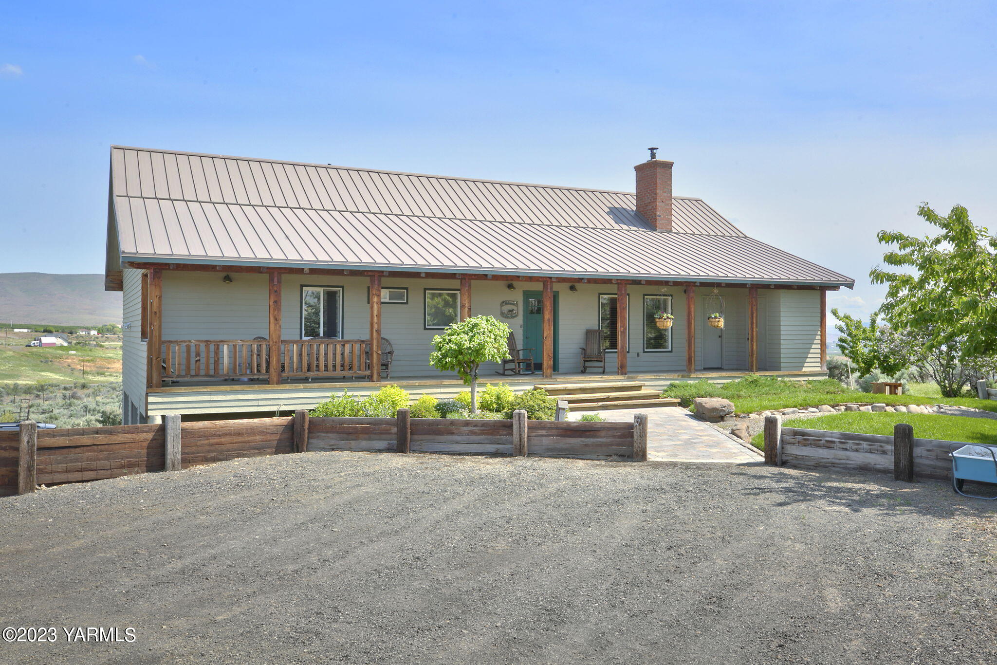 a view of house with swimming pool outdoor seating and house in the background