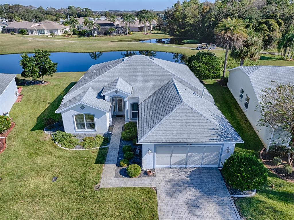 an aerial view of a house with outdoor space and lake view