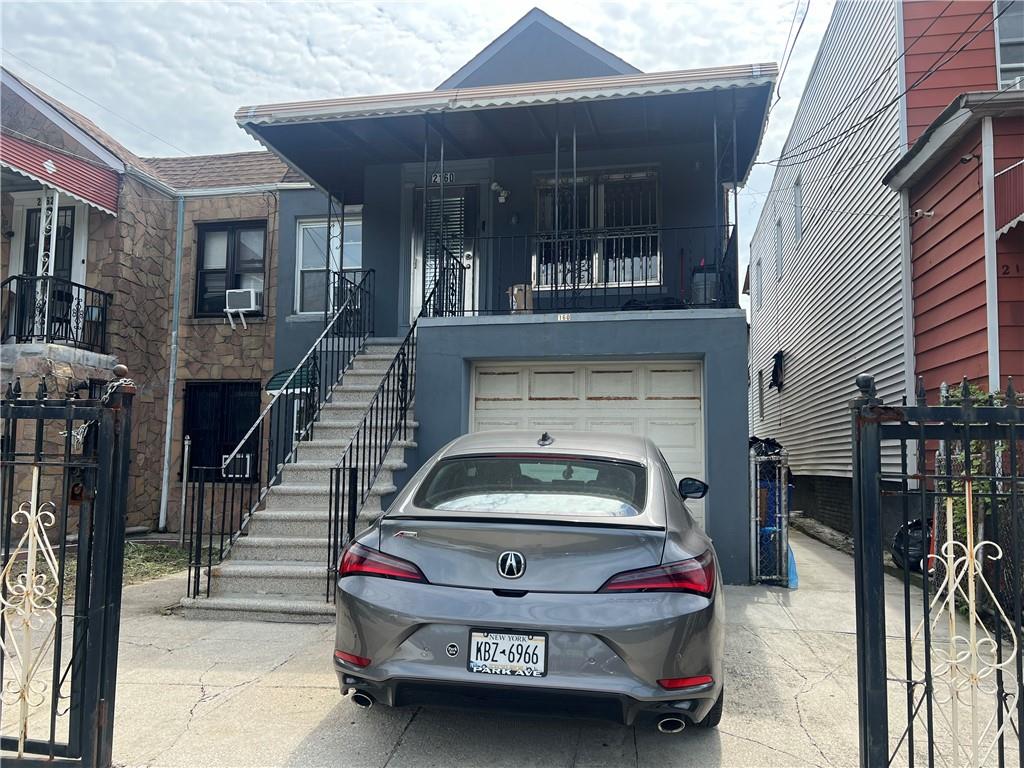 View of front facade featuring a garage