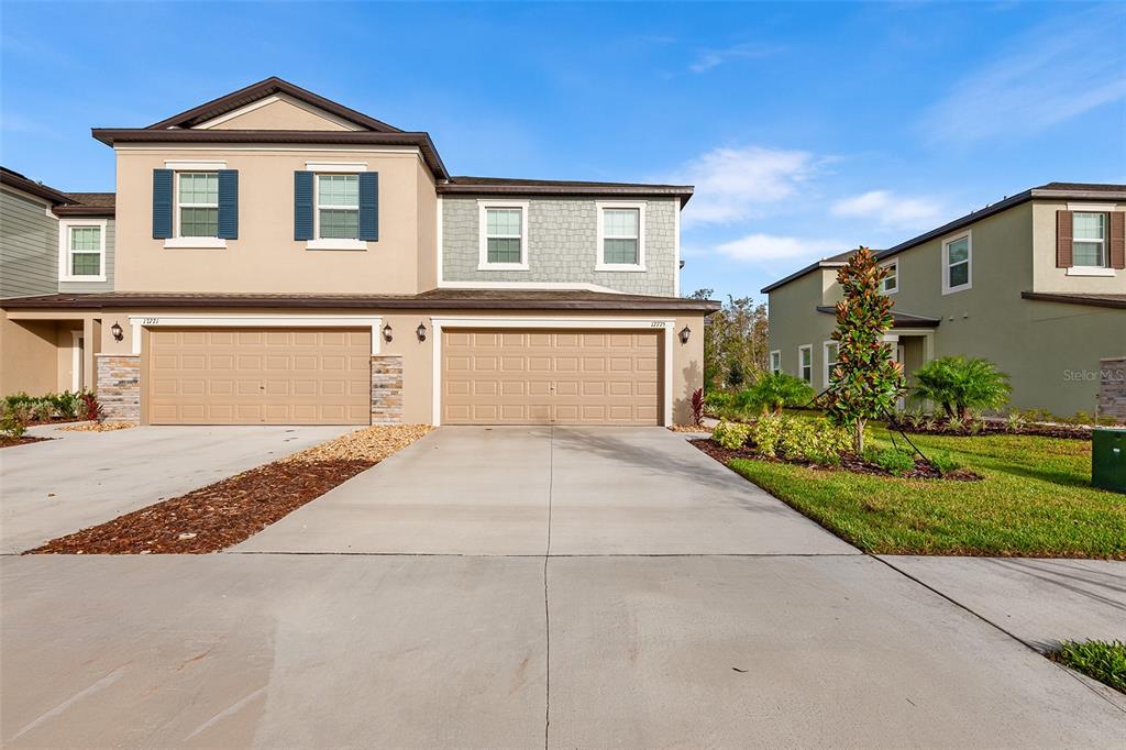 a front view of a house with a yard and garage