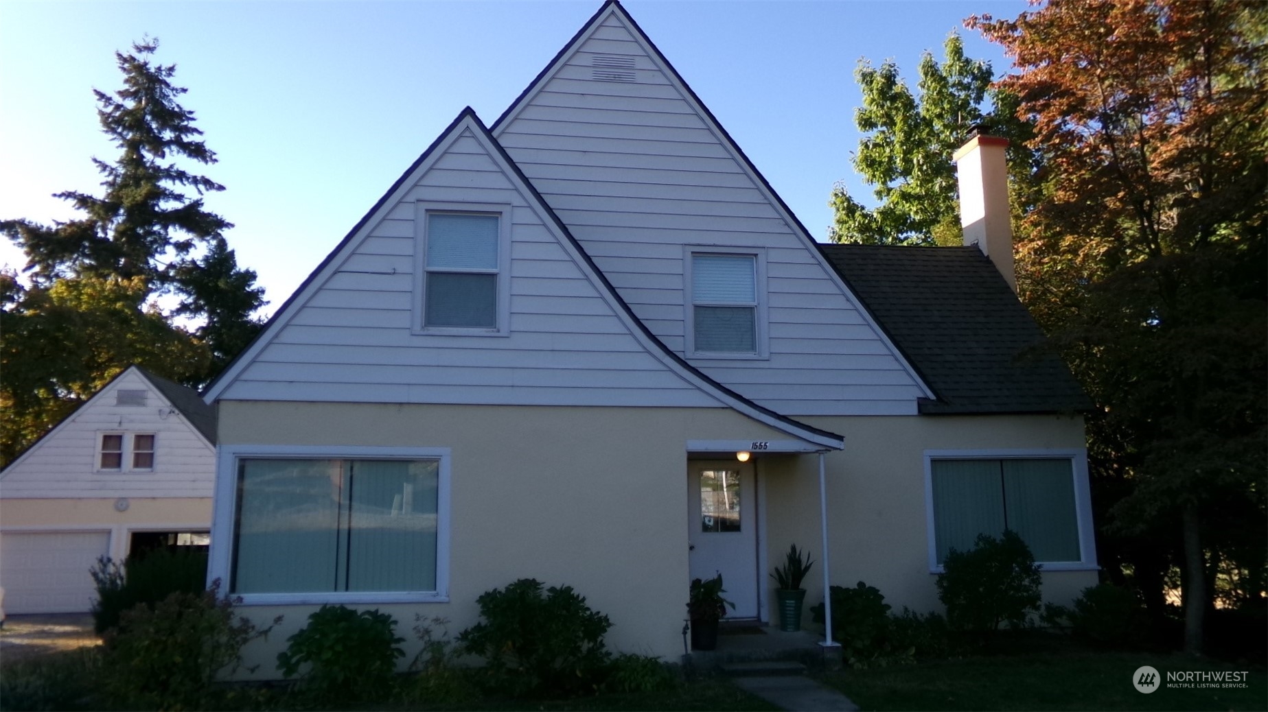 a front view of a house with a garden