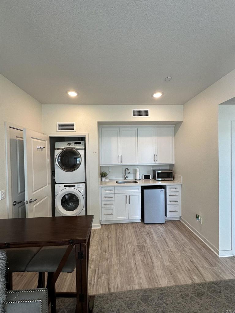 a kitchen with a wooden floor and white appliances