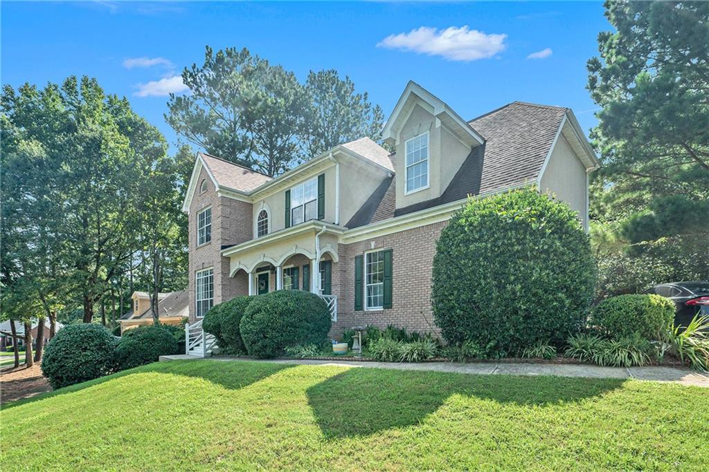 a front view of a house with a yard