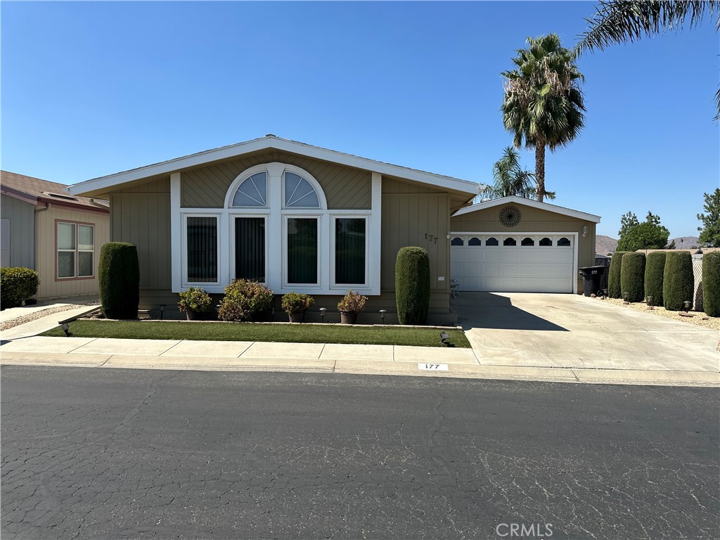 a front view of a house with yard garage and garage