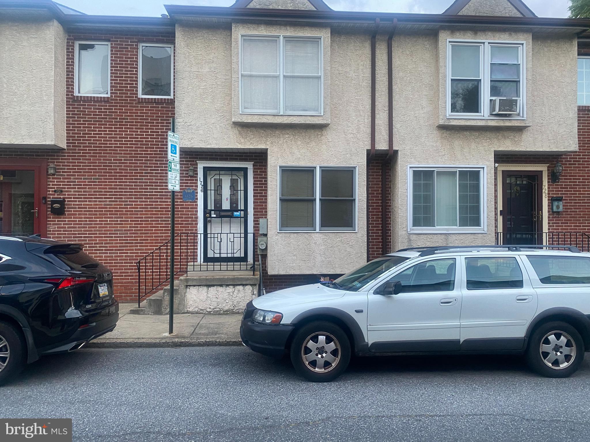 a view of a car parked in front of a house