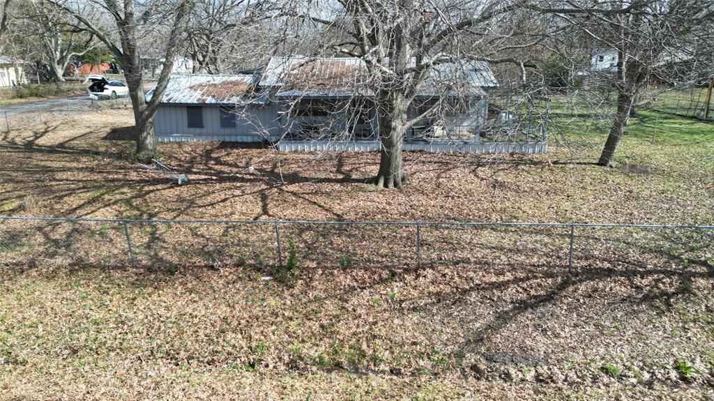 a view of a yard with a tree