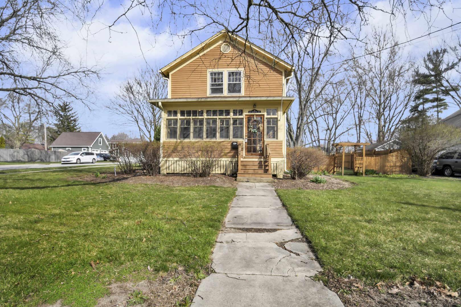 a front view of house with yard and green space