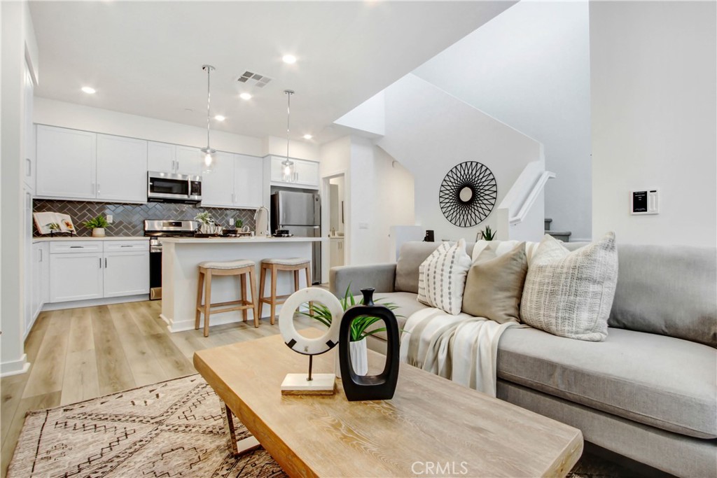 a living room with kitchen island furniture and a wooden floor