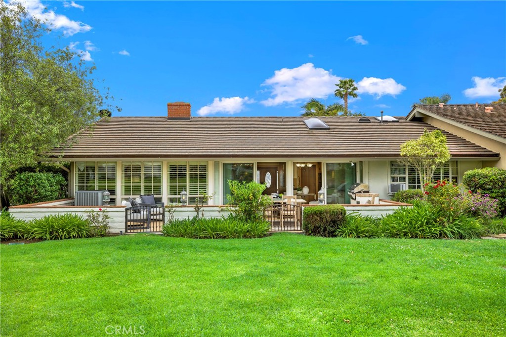 a front view of house with yard and outdoor seating