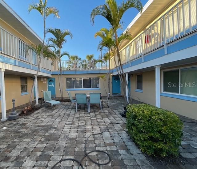 a view of a house with a patio and a yard