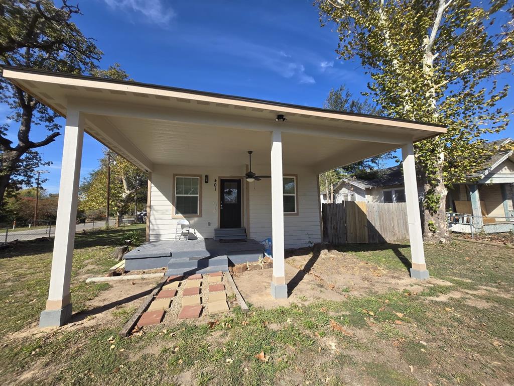 a view of a house with backyard porch and sitting area