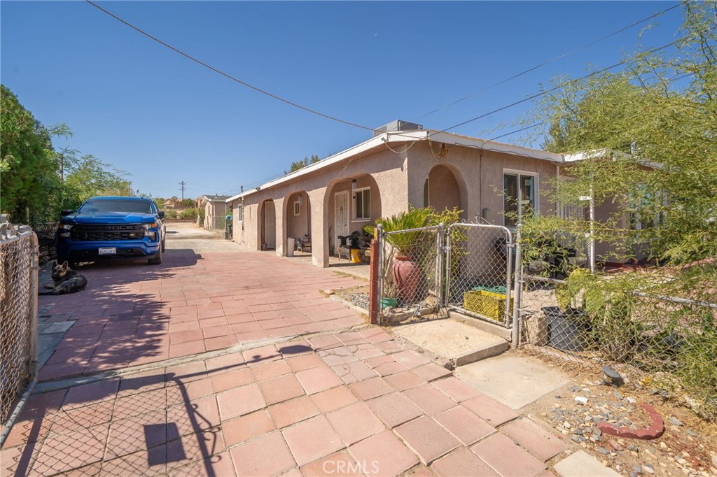 a view of a house with a bench in the patio