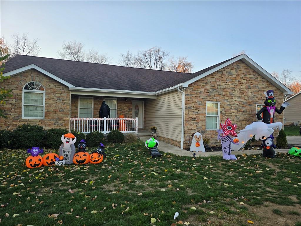 a group of people sitting in front of a house