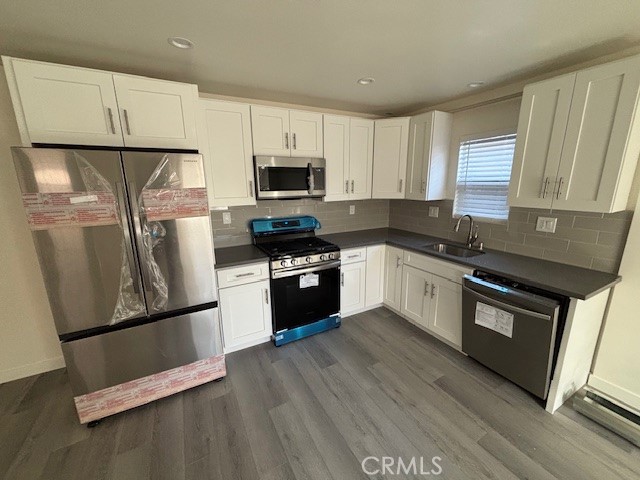 a kitchen with granite countertop white cabinets and stainless steel appliances