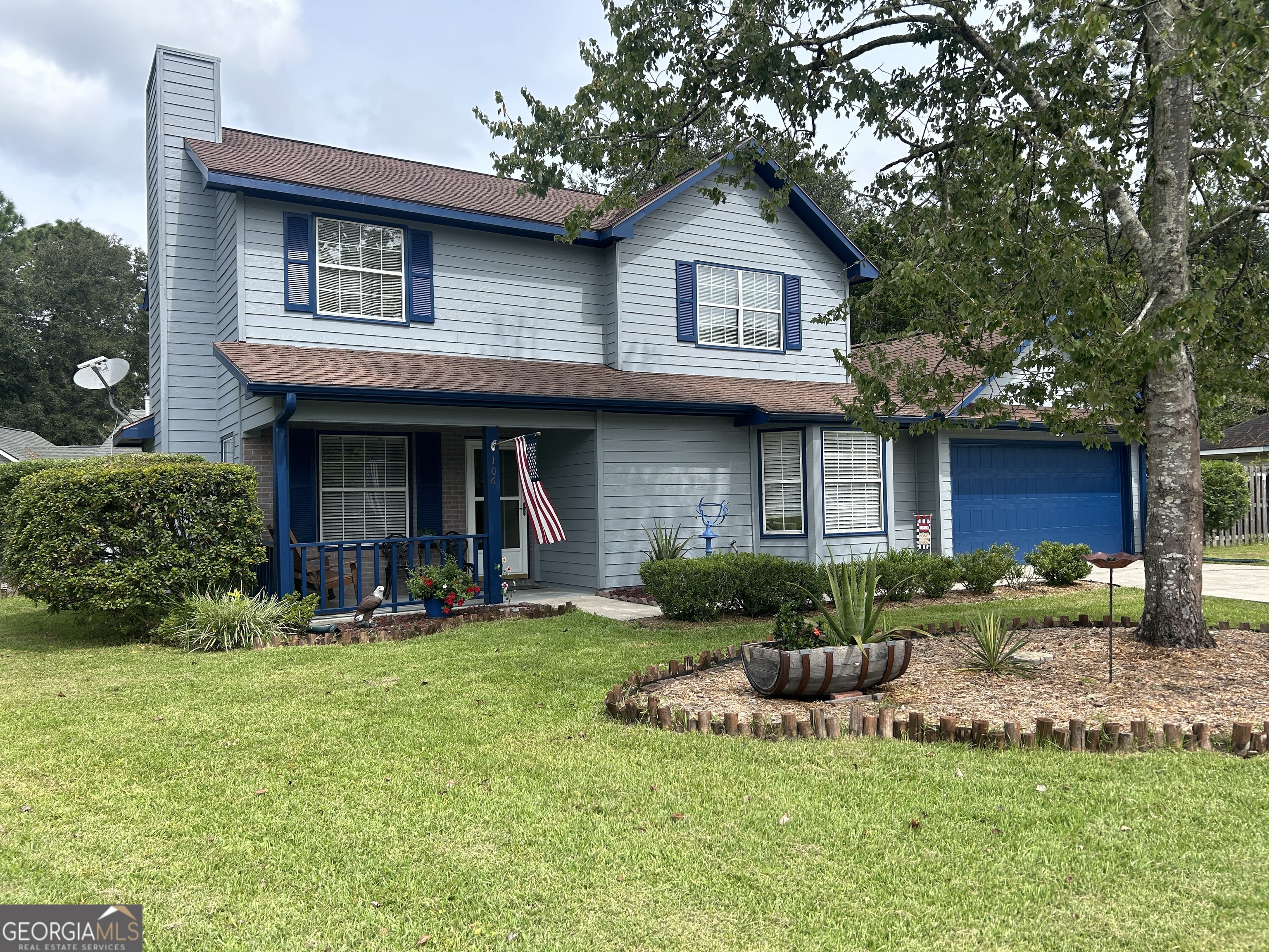 a view of a house with a yard porch and sitting area