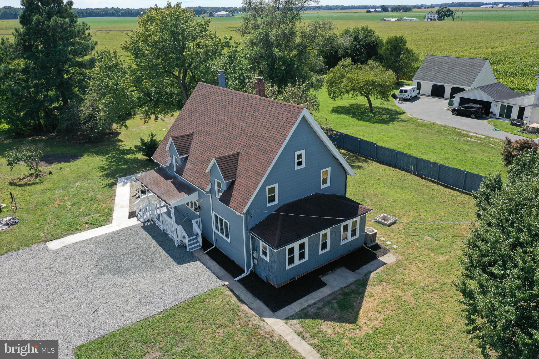 an aerial view of a house with a big yard