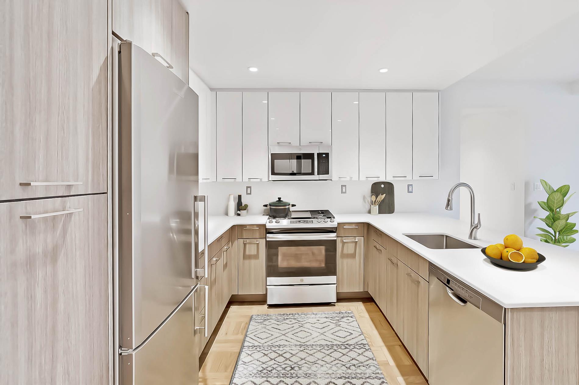 a kitchen with a sink cabinets and stainless steel appliances