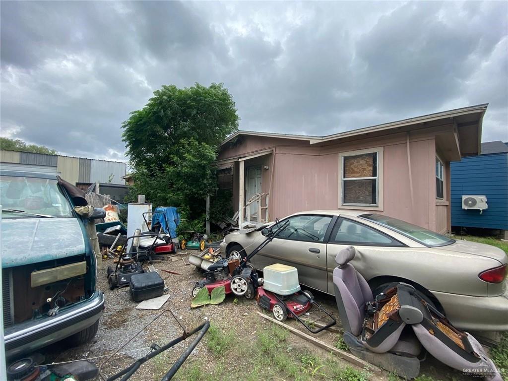 a front view of a house with cars parked