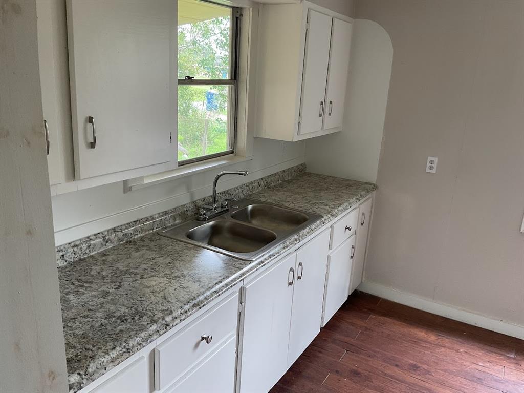 a kitchen with a sink cabinets and window