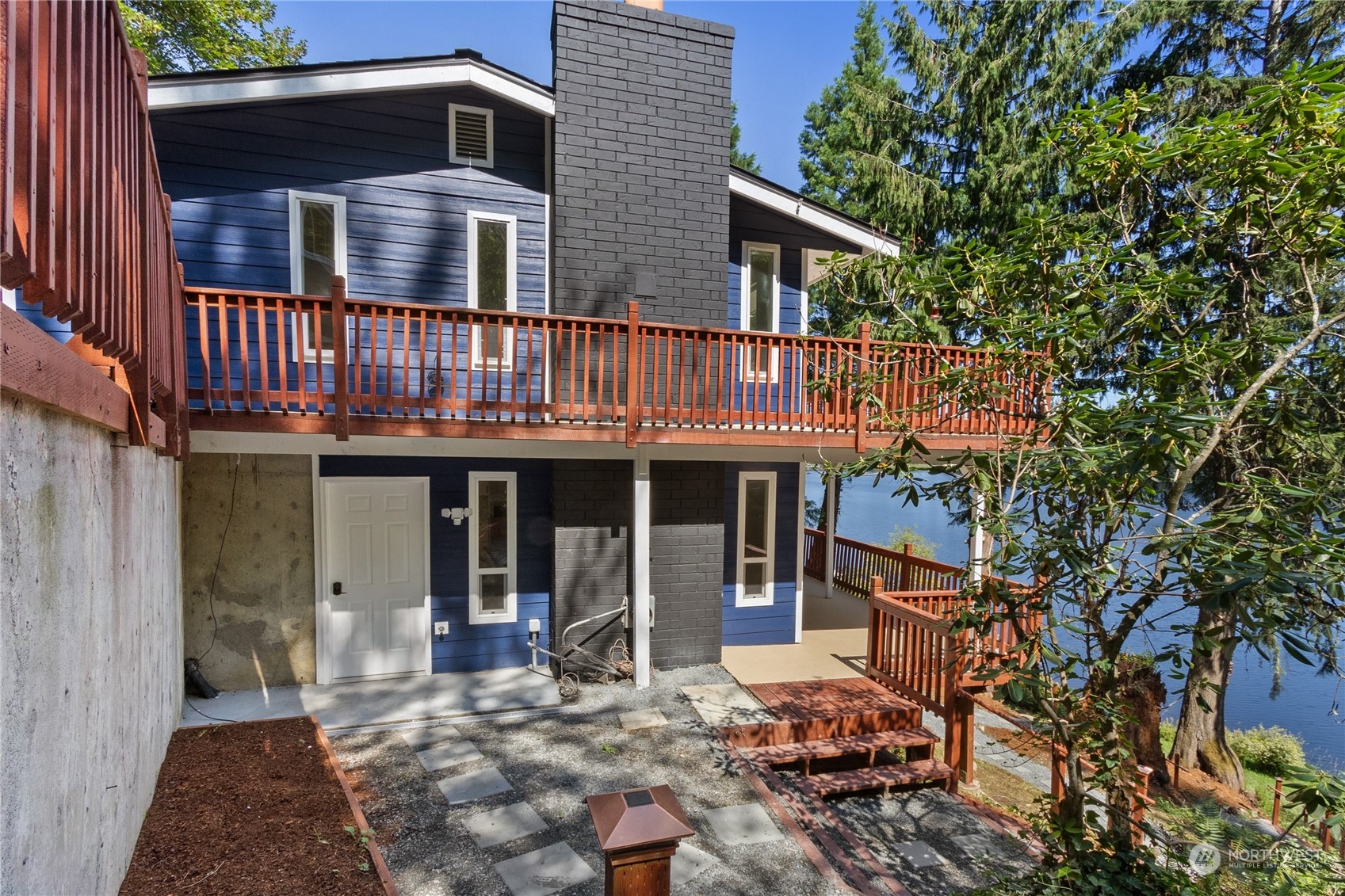 a view of a house with backyard porch and sitting area