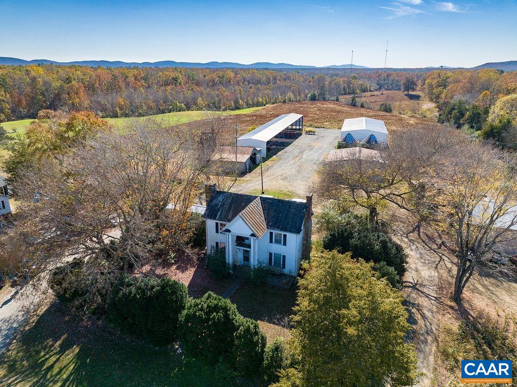 an aerial view of a house with a yard